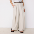 Women's beige maxi darted trousers with fluid wide leg and sculptural front drape by STATE OF HER