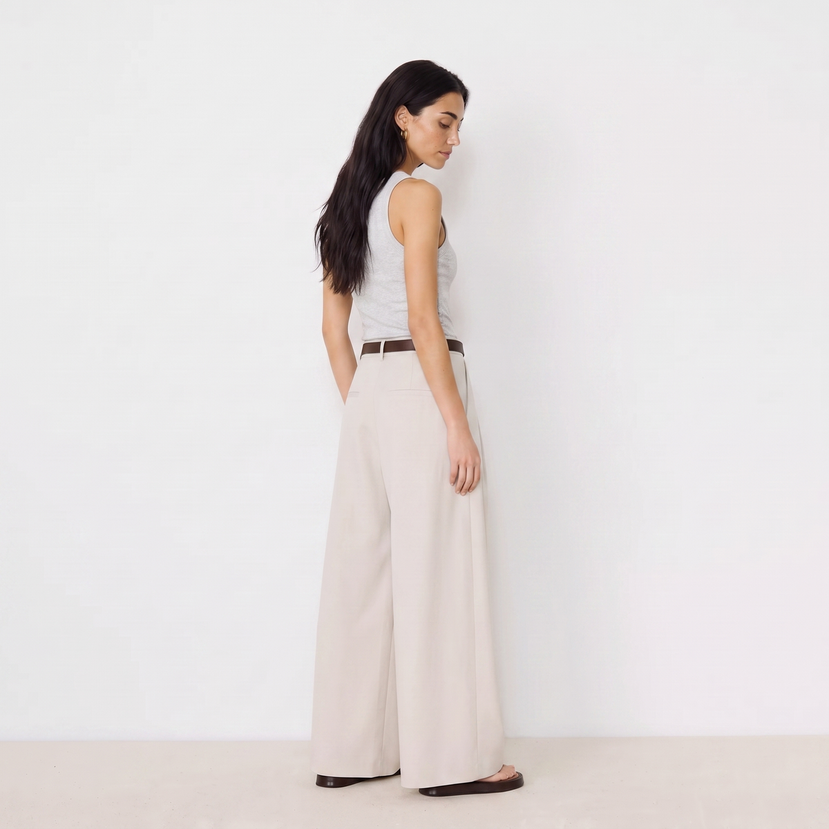 Women's beige maxi darted trousers with fluid wide leg and sculptural front drape by STATE OF HER