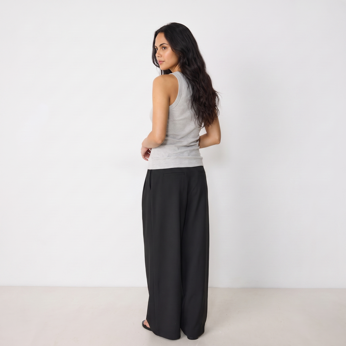 Women's black maxi darted trousers with fluid wide leg and sculptural front drape by STATE OF HER