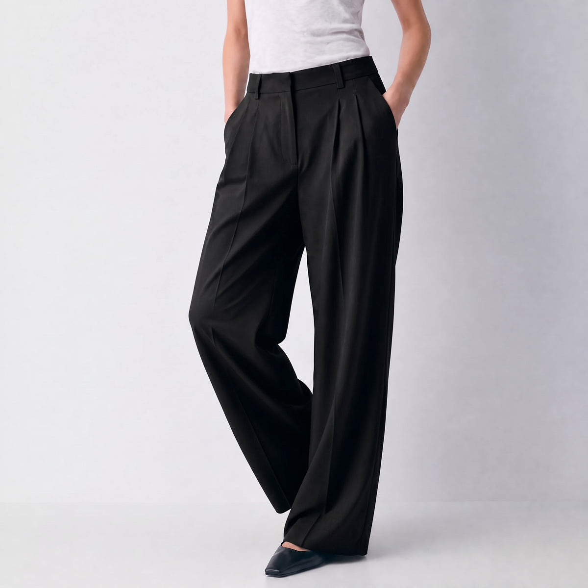 Women's black wide-leg tailored trousers with double front pleats and fluid drape by STATE OF HER