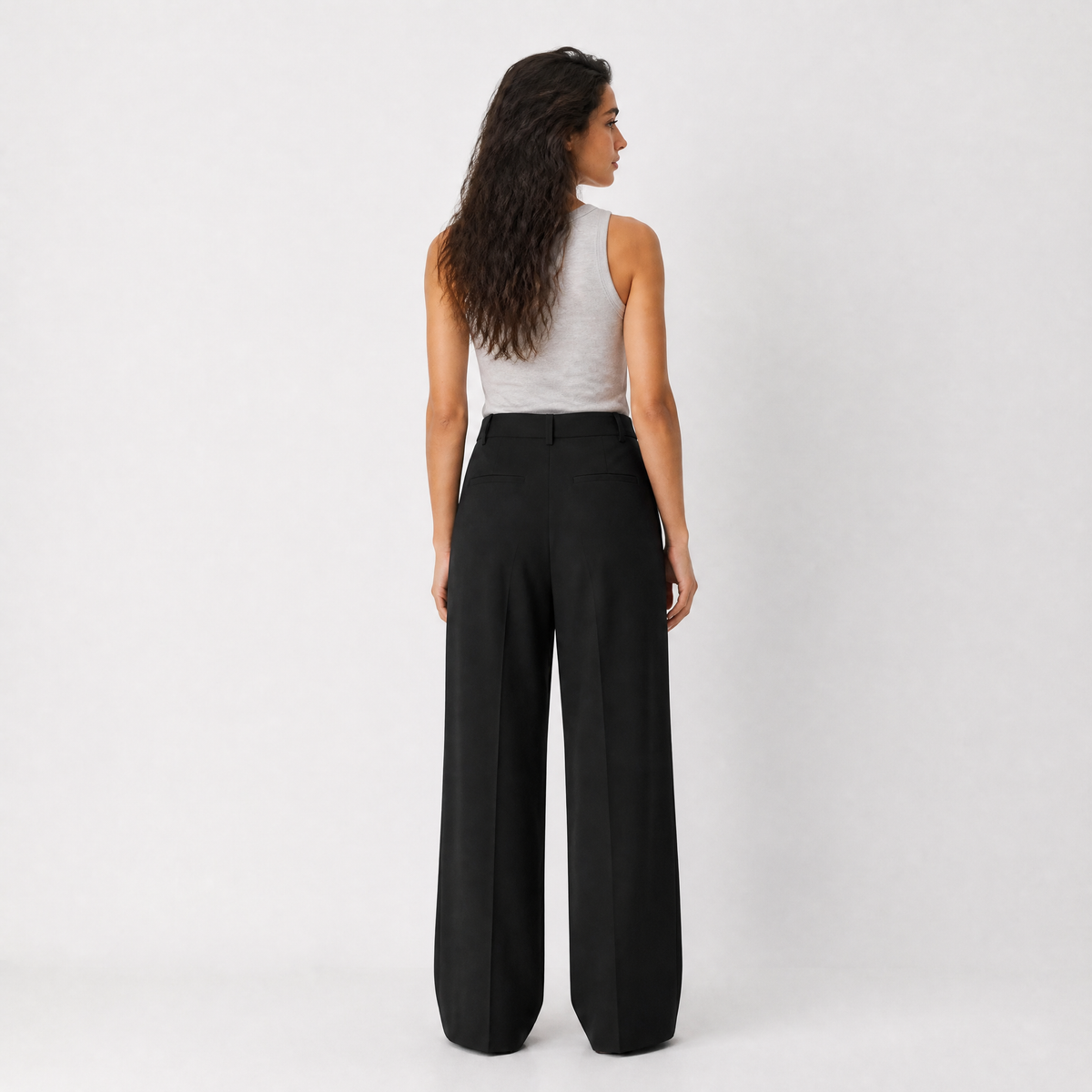 Women's black wide-leg tailored trousers with double front pleats and fluid drape by STATE OF HER