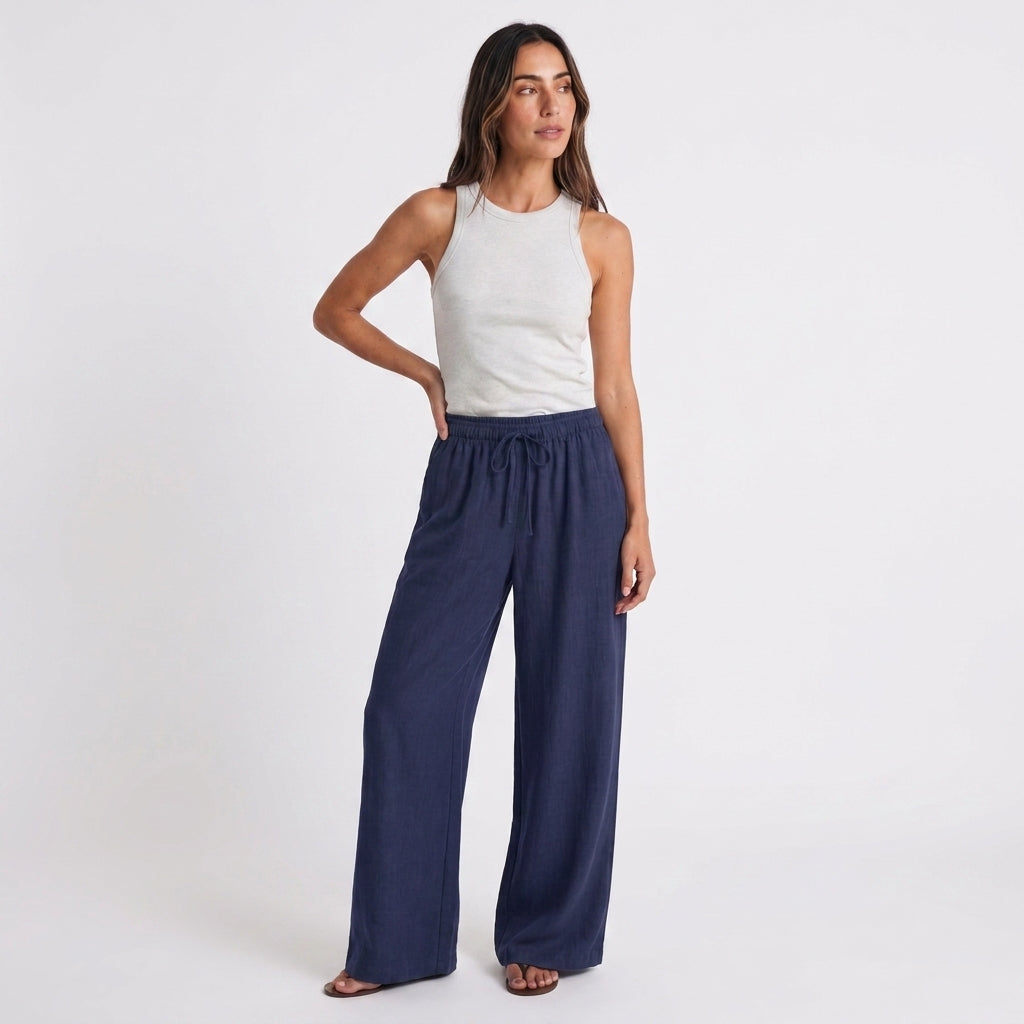 Women's blue linen straight-leg trousers with relaxed fit and pockets by STATE OF HER