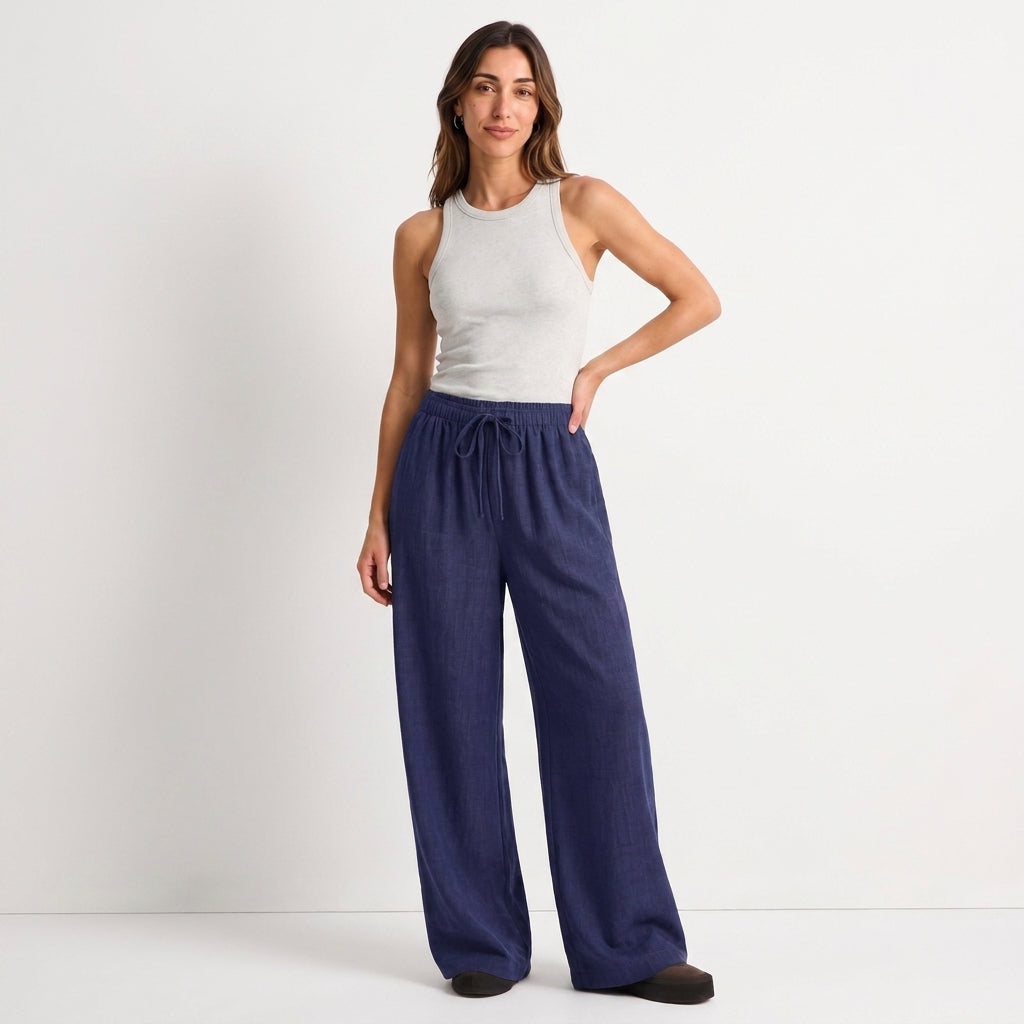 Women's blue linen straight-leg trousers with relaxed fit and pockets by STATE OF HER
