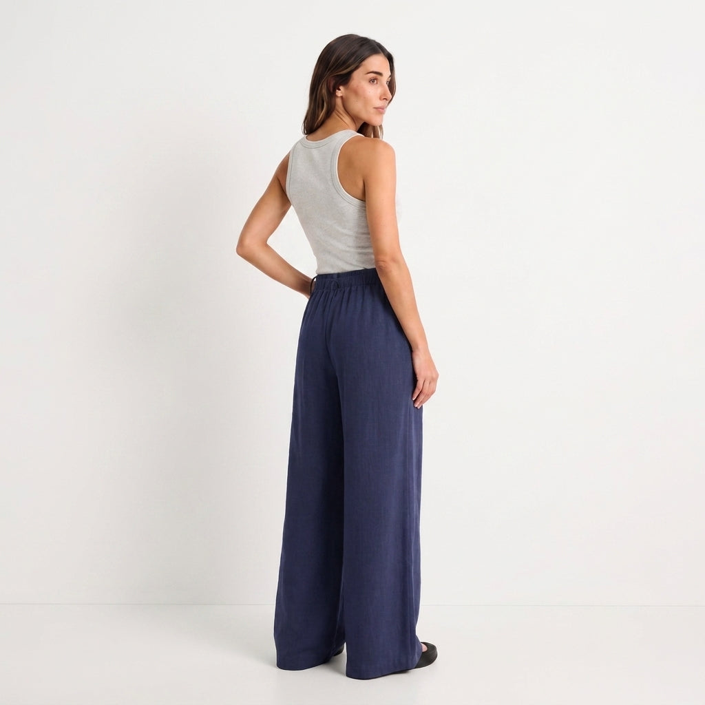 Women's blue linen straight-leg trousers with relaxed fit and pockets by STATE OF HER