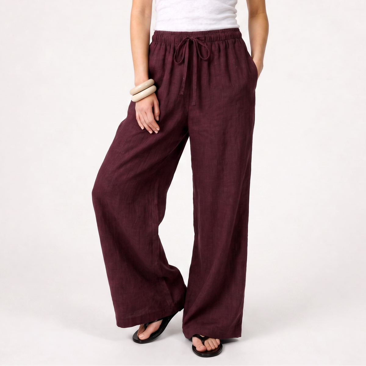 Women's burgundy linen straight-leg trousers with relaxed fit and pockets by STATE OF HER