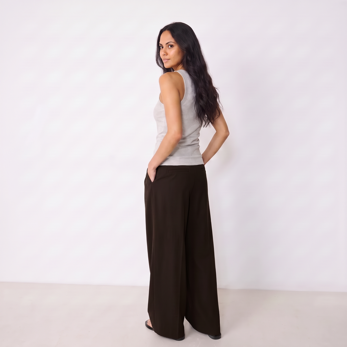 Women's dark brown maxi darted trousers with fluid wide leg and sculptural front drape by STATE OF HER