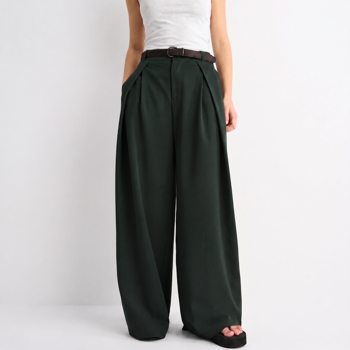 Women's green maxi darted trousers with fluid wide leg and sculptural front drape by STATE OF HER