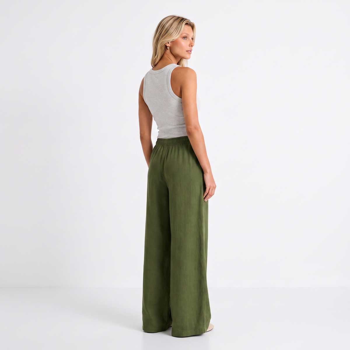 Women's olive linen straight-leg trousers with relaxed fit and pockets by STATE OF HER